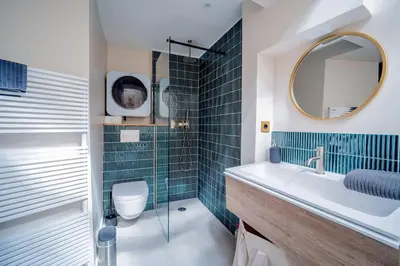 a bathroom with a sink and a toilet and a mirror at 25 rue Celony - Le Vendome - Jacuzzi - VideoProjecteur in Aix-en-Provence