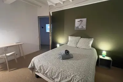 a bedroom with a bed with a hat on it at Maison Ange & Lice in Pernes-les-Fontaines