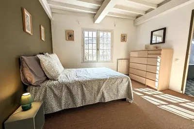a bedroom with a bed and a dresser at Maison Ange & Lice in Pernes-les-Fontaines