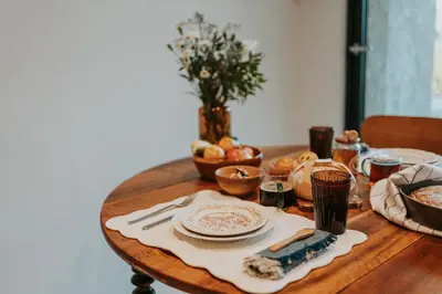 a table topped with plates and bowls of food at Logement de Charme vue Luberon - Rez-de-chaussée de maison, Jardin & Piscine in La Tour-dʼAigues