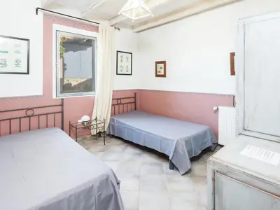 a bedroom with two beds and a window at Cottage in Oppède with Poolside Bliss in Maubec