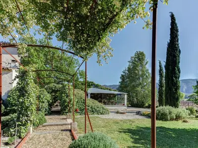 a garden with a swing and a building at Cottage in Oppède with Poolside Bliss in Maubec