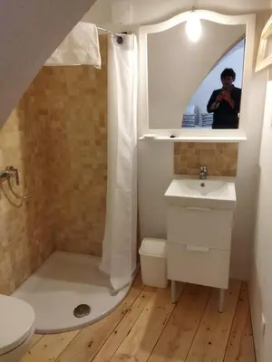 a bathroom with a sink and a toilet and a mirror at Les studettes du Beffroi in Cucuron