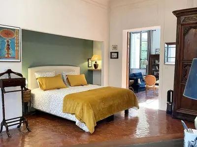 a bedroom with a bed with yellow pillows at Appart d exception 2 chambres quartier Mazarin in Aix-en-Provence