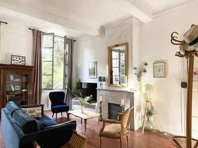 a living room with a blue couch and a fireplace at Appart d exception 2 chambres quartier Mazarin in Aix-en-Provence