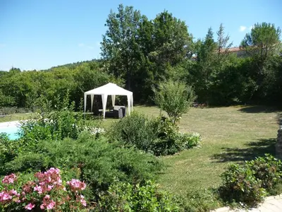 a white gazebo in the middle of a yard at Holiday Home Provence with Pool in Céreste