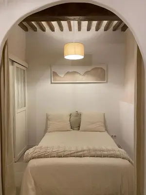 a bed in a room with an archway at Studio charmant hyper centre in Aix-en-Provence