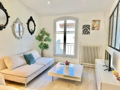 a living room with a couch and a table at Appartement chic, hyper centre in Aix-en-Provence
