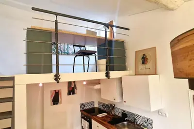 a kitchen with white cabinets and a sink at Cocon ensoleillé centre ville historique, Clim Wifi 4 people in Aix-en-Provence