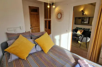 a bedroom with a bed with yellow pillows at Cocon ensoleillé centre ville historique, Clim Wifi 4 people in Aix-en-Provence