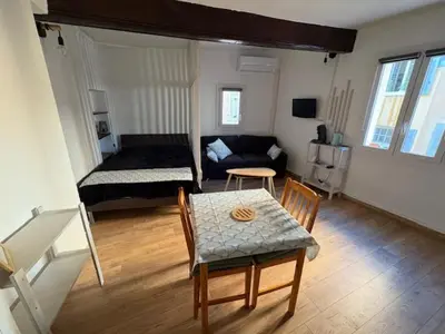 a living room with a table and a couch at Studio Cosy hyper centre Aix in Aix-en-Provence