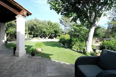 a garden with a couch in a yard at Villa La Raffinée, au coeur des garrigues du Luberon in Gordes