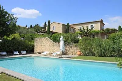 a swimming pool in front of a house at Villa l'Écrin, piscine et 3 terrasses in Gordes