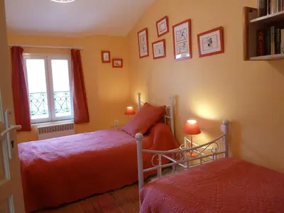 a bedroom with two beds and a window at La Calvinette in Pernes-les-Fontaines