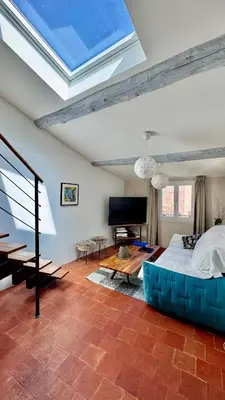 a bedroom with a large bed with a blue couch at artist plein centre ville historique in Aix-en-Provence