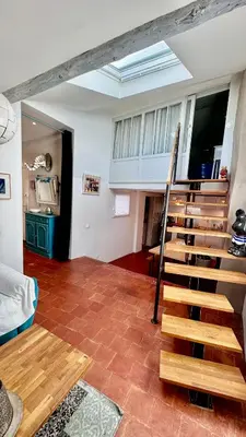 a living room with a staircase in a house at artist plein centre ville historique in Aix-en-Provence
