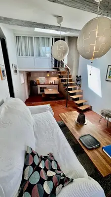 a living room with a bed and a staircase at artist plein centre ville historique in Aix-en-Provence