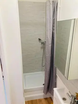 a shower in a bathroom with a shower curtain at Maisonnette T1 au calme à 1min à pied de la gare SNCF in Miramas