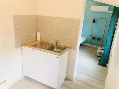 a small kitchen with a sink and a bathroom at Maisonnette T1 au calme à 1min à pied de la gare SNCF in Miramas