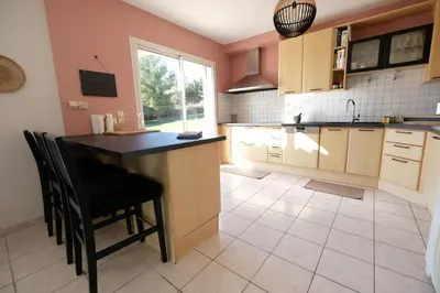 a kitchen with a counter and a table and chairs at villa avec piscine aureille alpilles paragi ls1-449 in Aureille