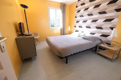 a bedroom with a bed with a checkered wall at villa avec piscine aureille alpilles paragi ls1-449 in Aureille