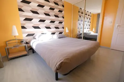 a bedroom with a large bed with a checkered wall at villa avec piscine aureille alpilles paragi ls1-449 in Aureille