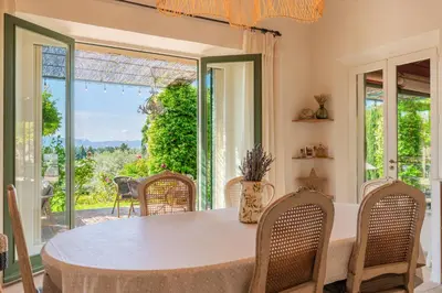 a dining room with a table and chairs at Le Mas Elaïa, votre havre familial avec piscine privée in Eyragues