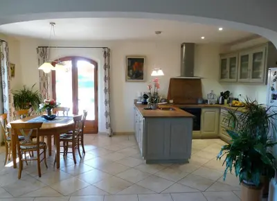 a kitchen with a table and a dining room at Villa avec piscine Saint Remy de Provence LS1-196 in Saint-Rémy-de-Provence