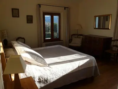 a bedroom with a large bed and a window at Villa avec piscine Saint Remy de Provence LS1-196 in Saint-Rémy-de-Provence