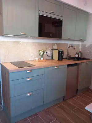 a kitchen with blue cabinets and a counter top at Studio entièrement rénové in Cavaillon