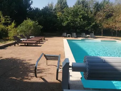 a pool with several chairs and a row at #Villa Théo# Grande villa avec piscine in Apt