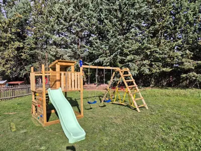a wooden playground with a slide and a ladder at #Villa Théo# Grande villa avec piscine in Apt