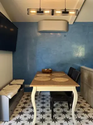 a dining room with a table and chairs and a couch at Maisonnette climatisée in Aix-en-Provence