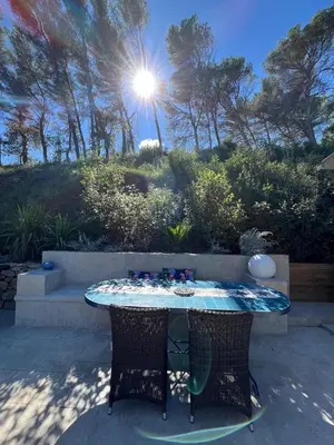 a table with chairs and the sun in the background at Maisonnette climatisée in Aix-en-Provence