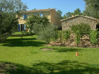 a yard with a house and trees and a cone at Location avec piscine Roussillon LS2-91 in Roussillon