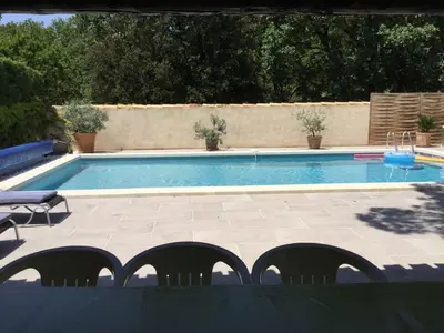 a swimming pool with chairs in front of it at Maison avec piscine privative Taillades Luberon LS2-281 in Les Taillades