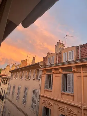 a group of buildings with a sunset in the background at T2 lumineux hyper centre Aix en Provence à quelques metres du Cours Mirabeau pour 1 à 5 personnes in Aix-en-Provence
