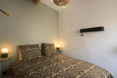a bedroom with a bed with two pillows at La Suite Mazarin in Aix-en-Provence