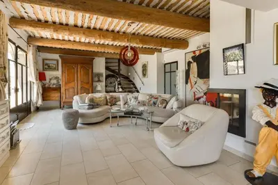 a large living room with couches and a fireplace at Chambre d'hôtes le Jardinage in Cabrières-dʼAvignon