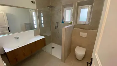 a bathroom with a shower and a sink and a toilet at Au pied du Luberon in Les Taillades