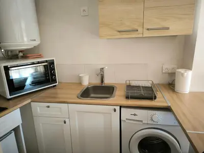 a kitchen with a sink and a microwave at Le Nid plein centre in Salon-de-Provence