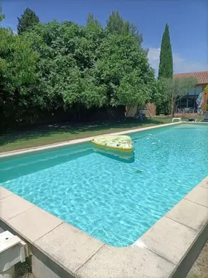 a large swimming pool with an inflatable at Superbe appartement neuf au cœur de la Provence. in Entraigues-sur-la-Sorgue