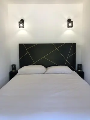a bedroom with a large bed with two pillows at Gite 5 pers en Provence avec grand jardin & piscine partagés - 5 people holiday home with shared swimming pool & garden in Provence in Cornillon-Confoux