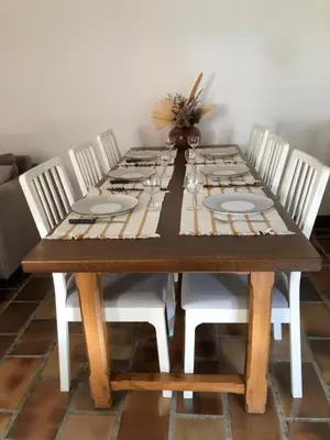 a wooden table with four white chairs around it at Gite 5 pers en Provence avec grand jardin & piscine partagés - 5 people holiday home with shared swimming pool & garden in Provence in Cornillon-Confoux