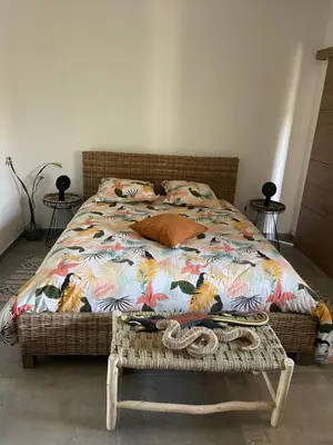 a bedroom with a bed with a colorful comforter at Entre ciel et terre in Le Thor