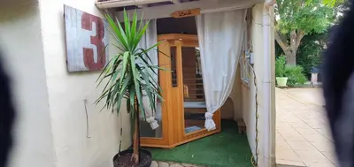 a house with a potted plant in the doorway at Entre ciel et terre in Le Thor