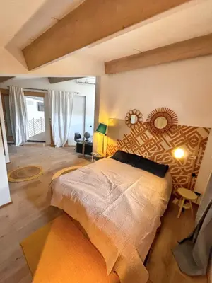 a bedroom with a large bed in a room at Maison spacieuse avec piscine à Aix-en-Provence in Aix-en-Provence