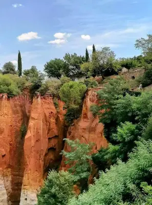 a view of a mountain with trees and rocks at Chambre DURFORT in Sault-de-Vaucluse