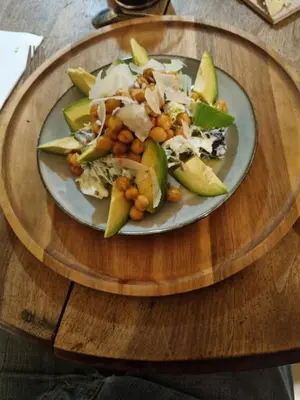 a plate of food on a wooden table at Chambre DURFORT in Sault-de-Vaucluse