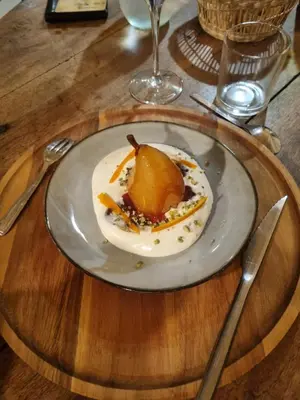 a plate of food on a wooden table at Chambre DURFORT in Sault-de-Vaucluse